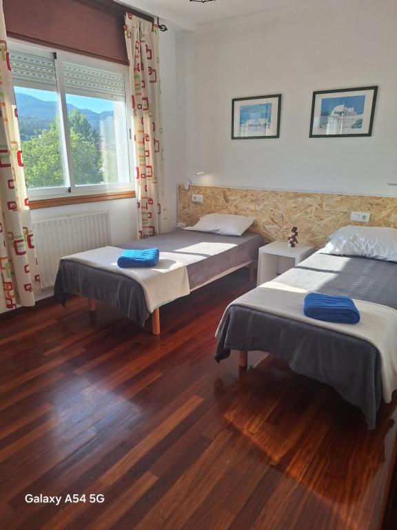 a room with two beds and a window at St Jamesway Tuy in Tui