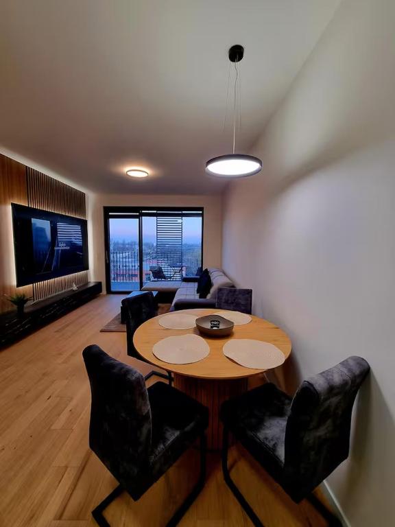 a living room with a table and chairs and a couch at Big Balcony & Free parking - PREMIUM Apartment in Bratislava