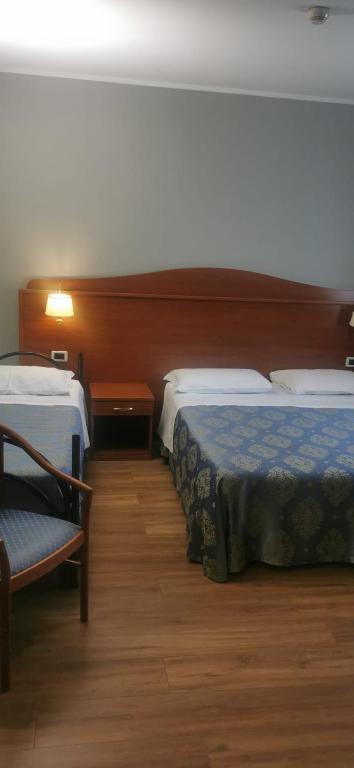 Postel nebo postele na pokoji v ubytování Hotel Rigolfo