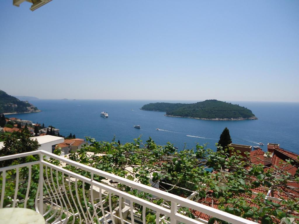 a balcony with a view of a body of water at Peric Rooms Dubrovnik in Dubrovnik
