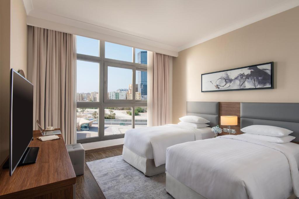 Postel nebo postele na pokoji v ubytování Marriott Executive Apartments Doha, Le Mirage City Walk