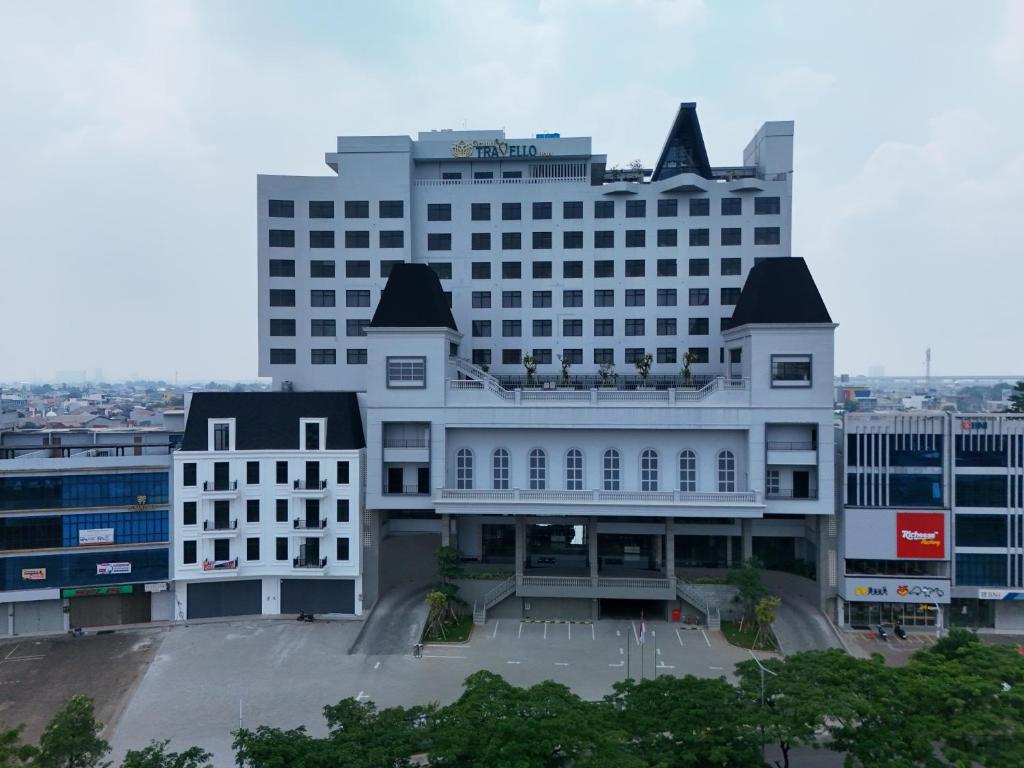 a large white building with a lot of windows at Grand Travello Hotel Bekasi in Kedaung