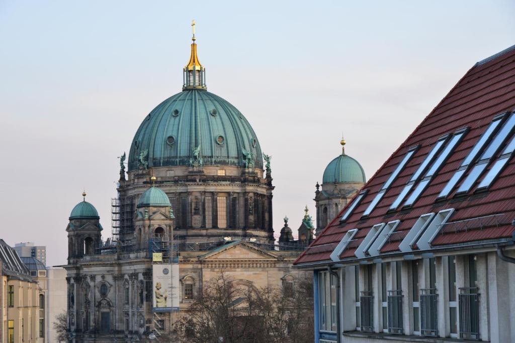 a building with a green domes on top of it at Monbijou Hotel in Berlin