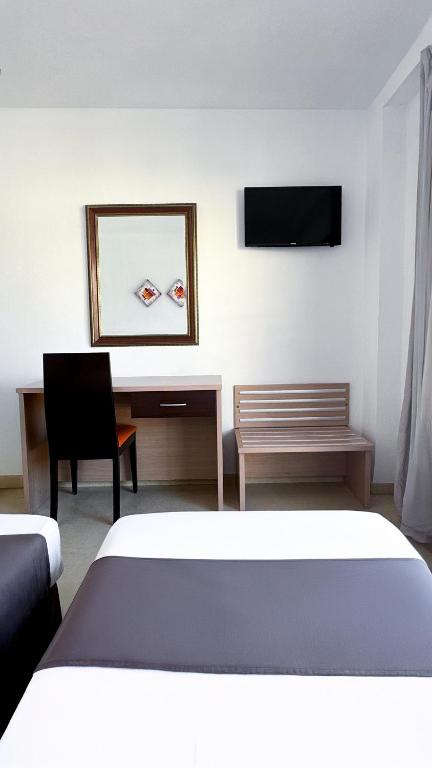 Postel nebo postele na pokoji v ubytování Hotel Primavera
