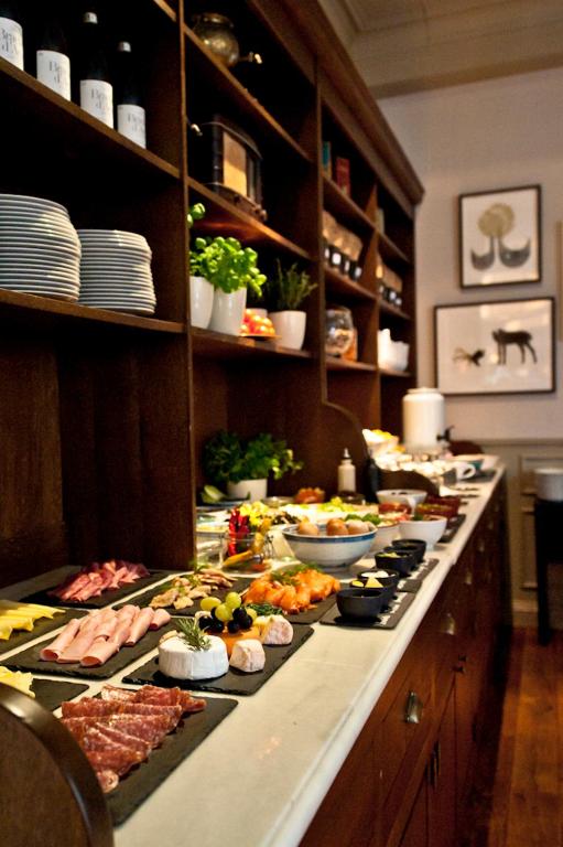 a buffet line with many different types of food at Monbijou Hotel in Berlin