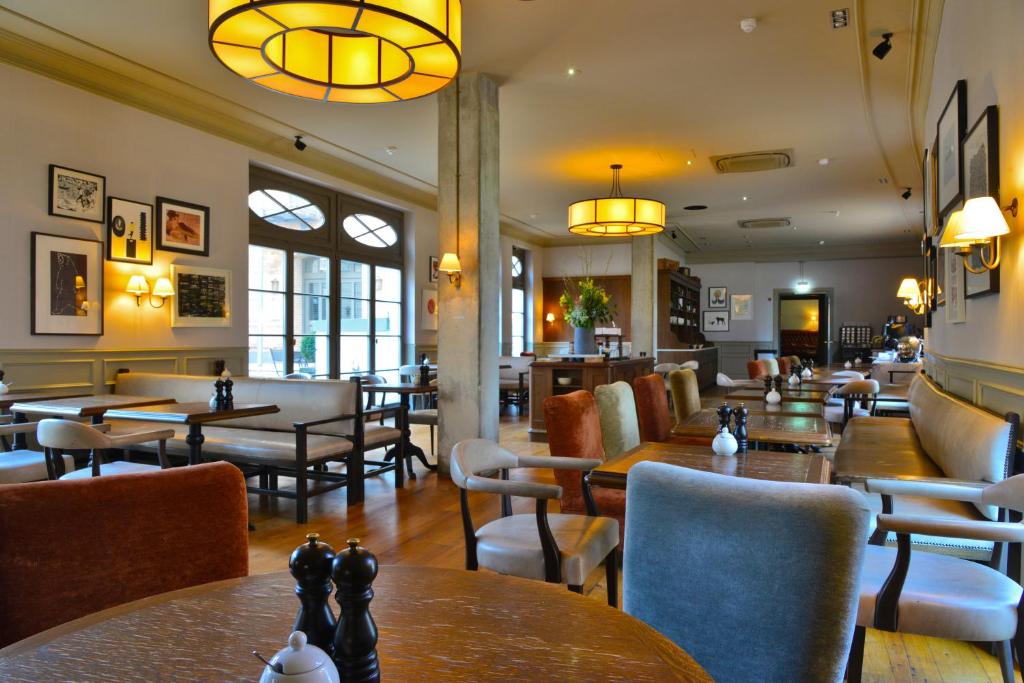 a restaurant with tables and chairs and a chess board at Monbijou Hotel in Berlin