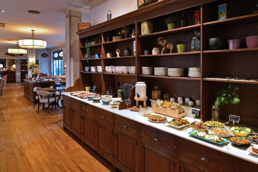 a buffet line with many plates of food on it at Monbijou Hotel in Berlin