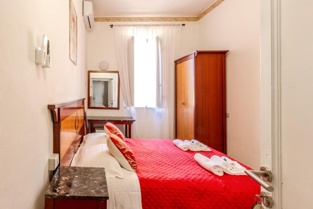 Postel nebo postele na pokoji v ubytování Hotel Corallo Follonica