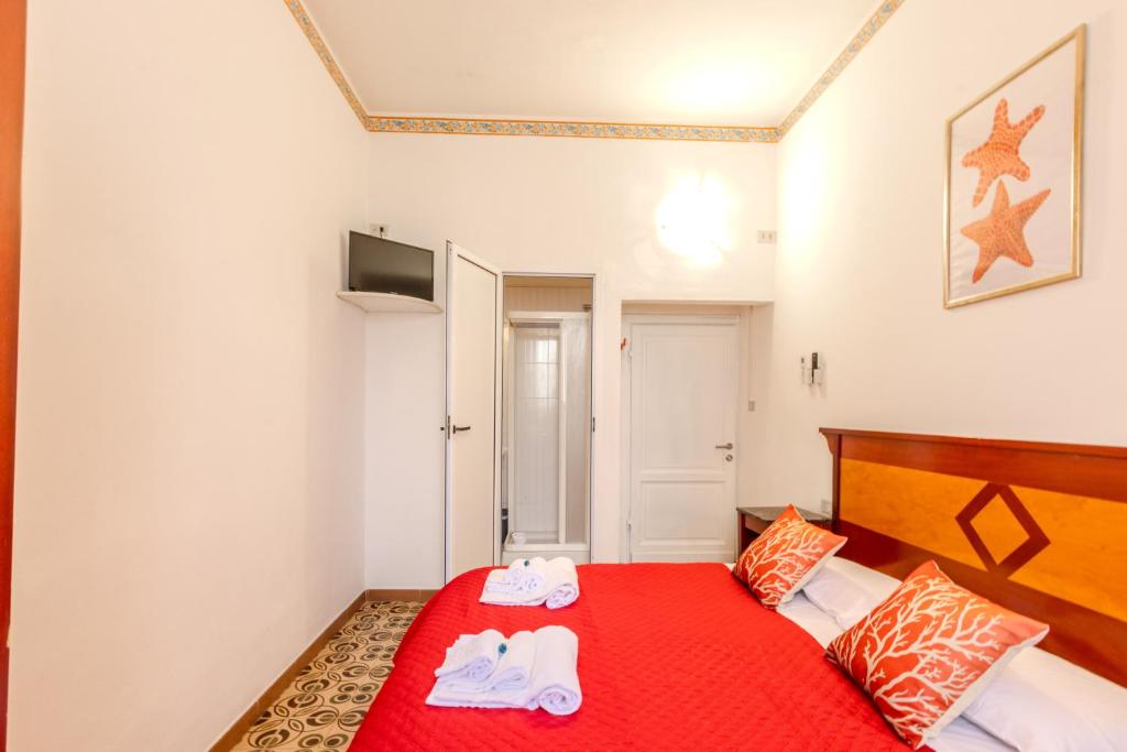 Postel nebo postele na pokoji v ubytování Hotel Corallo Follonica