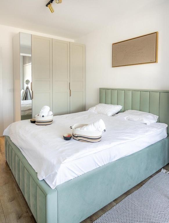 a large bed with two towels on top of it at Blvd Ivory Pipera Studio 43A in Voluntari