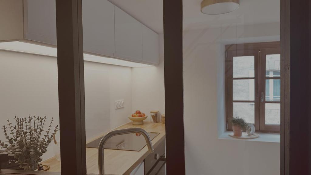 a kitchen with a sink and a window at La Maison de Victoire et Alix in Pontrieux