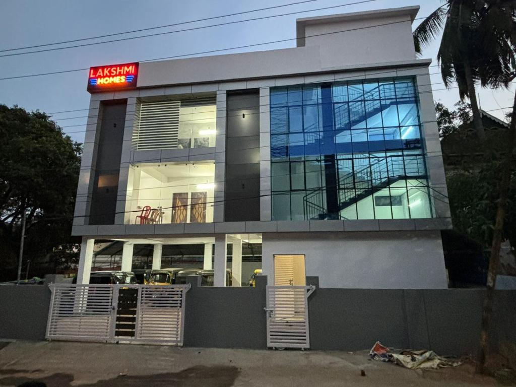 a building with a sign on top of it at Lakshmi Home 1 in Trichūr