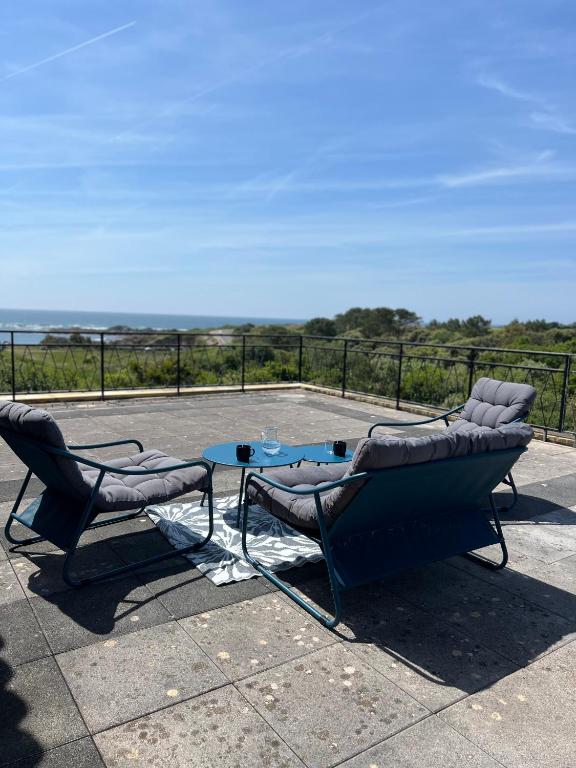 deux chaises et une table sur une terrasse dans l'établissement Villa Angeli, à Les Sables-dʼOlonne