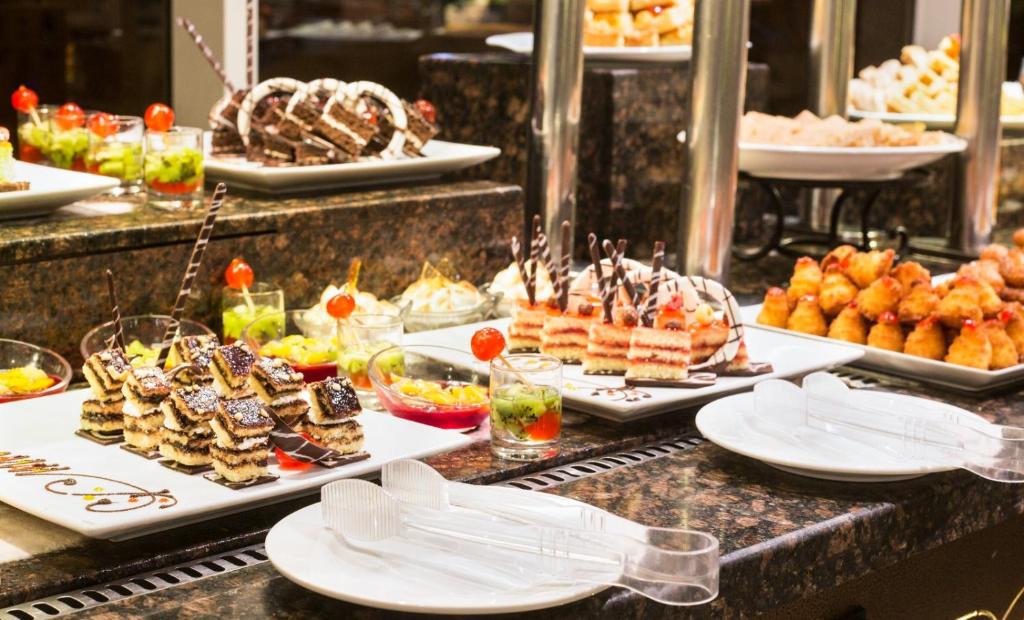 a buffet with several plates of food on a table at V Hotel Sharm El Shiekh in Sharm El Sheikh