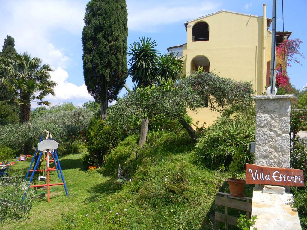 a garden with a ladder and a building at Villa Efterpi in Kontokali