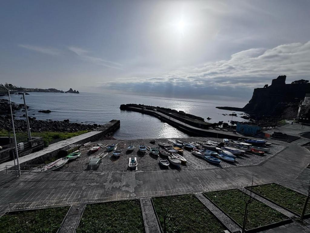 a group of boats are parked in a harbor at Porticciolo sea view in Aci Castello