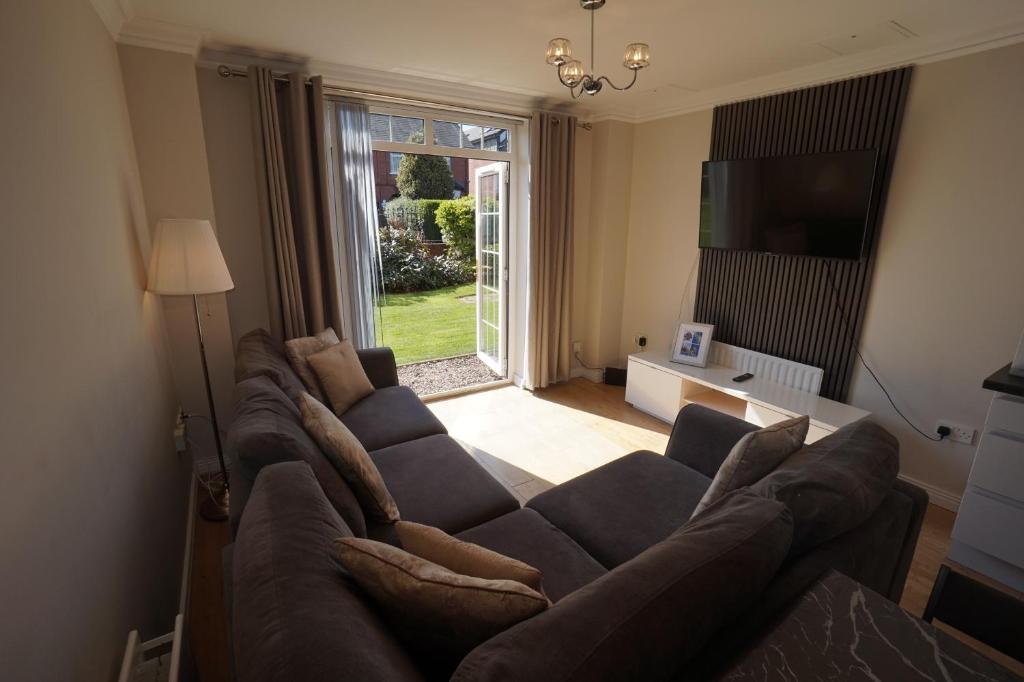 a living room with a couch and a large window at Stockmans Stay, Belfast in Belfast