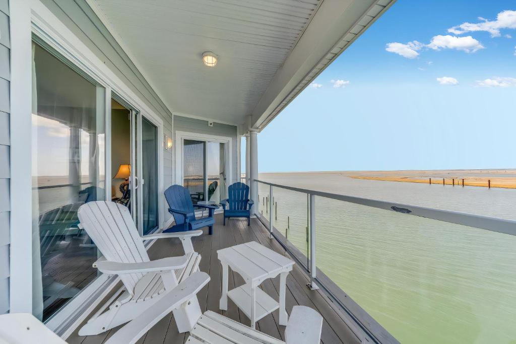 a balcony with chairs and a view of the beach at Sunset Bay Villa 319 - Bella Vista in Chincoteague