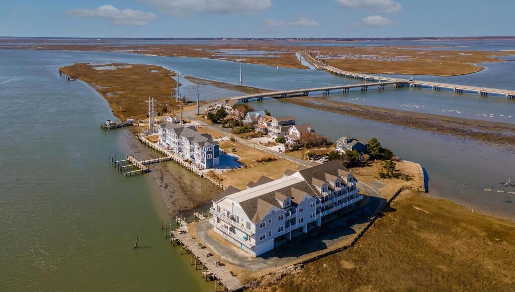 an aerial view of a building next to the water at Ducks, Docks, And Flip Flops in Chincoteague