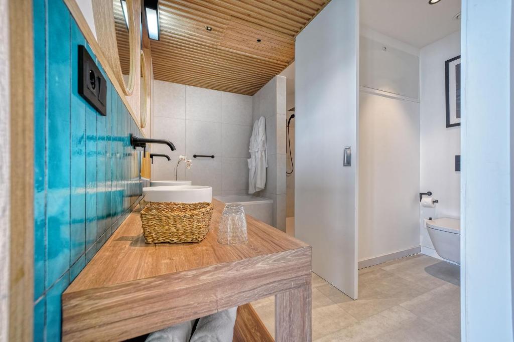a bathroom with a sink and a toilet at HOVIMA Suites Costa Adeje in Adeje