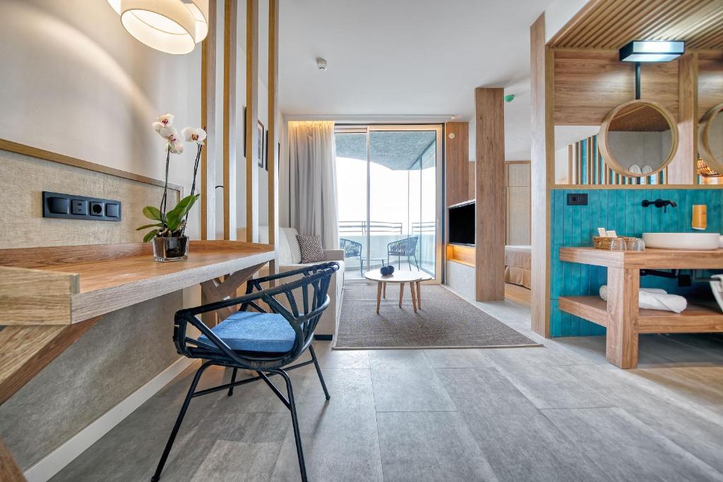 a bathroom with a desk and a chair in a room at HOVIMA Suites Costa Adeje in Adeje