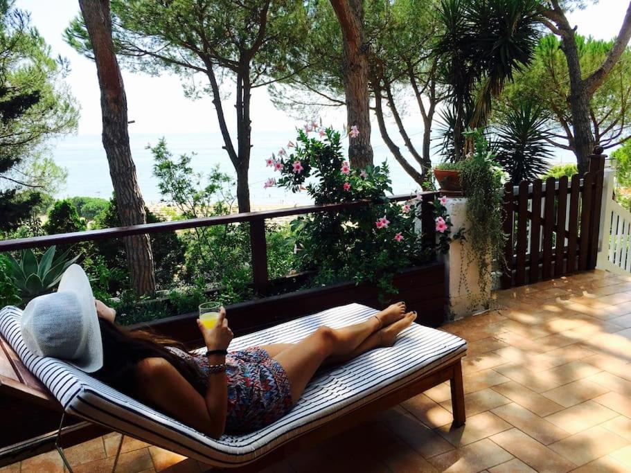 a woman laying on a hammock on a patio at Villa Fiorella in Sperlonga