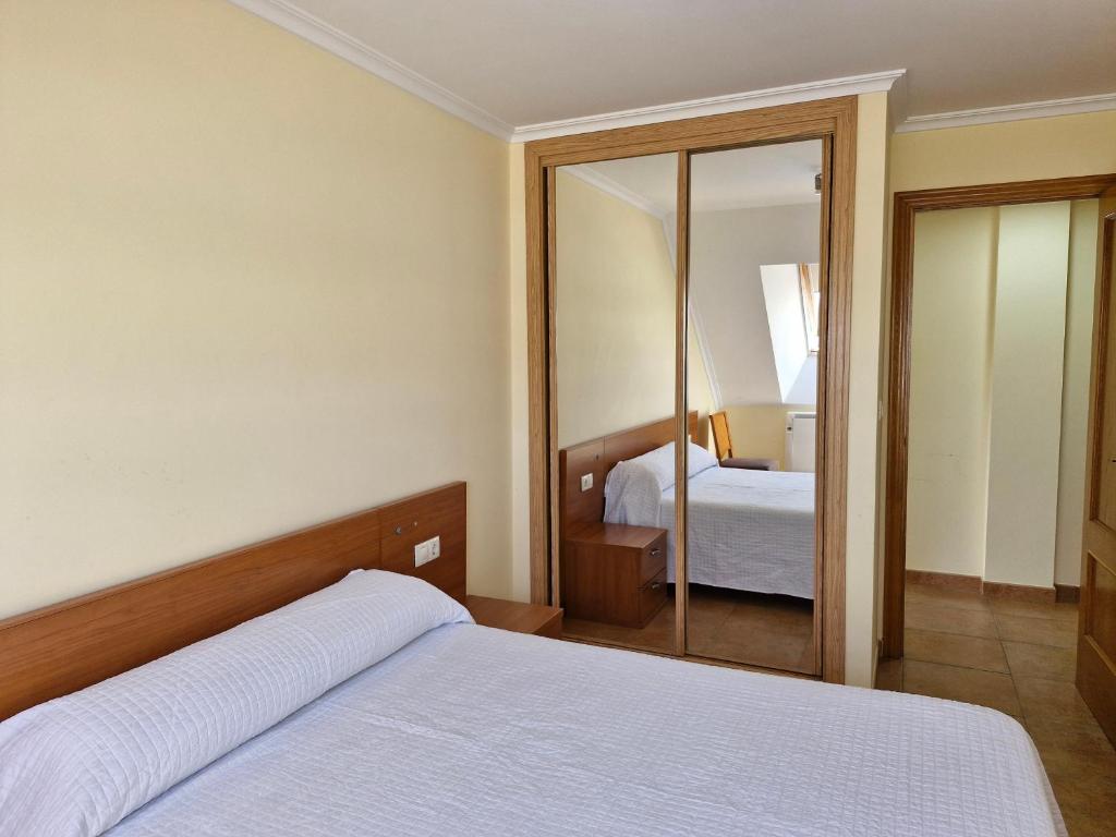 A bed or beds in a room at Apartamento Foz Playa