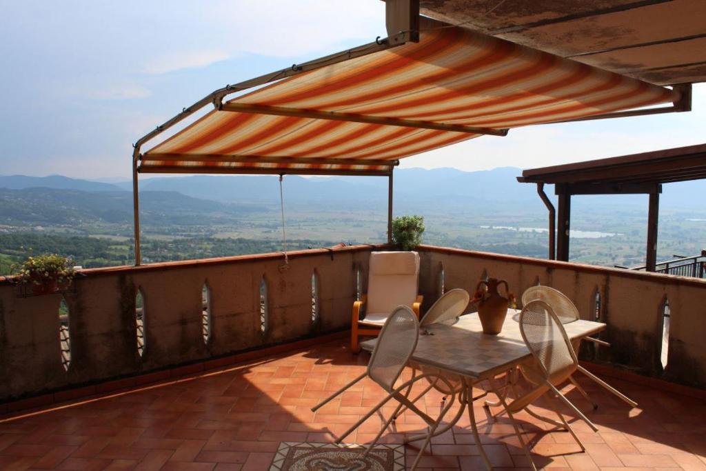 a table and chairs on a balcony with a view at La Casa nel Sole Poggio Bustone in Poggio Bustone