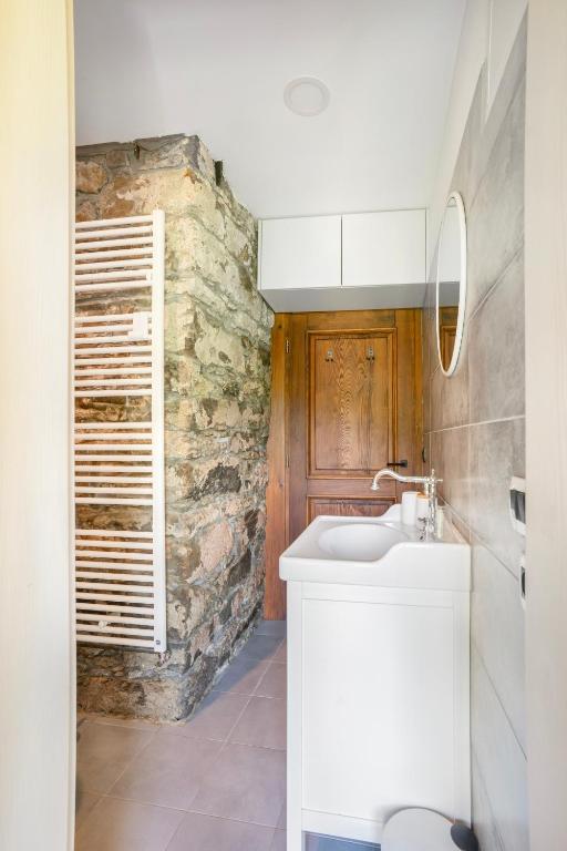 a bathroom with a sink and a stone wall at Kuća za odmor “Dobra” - Skrad, Gorski kotar in Skrad