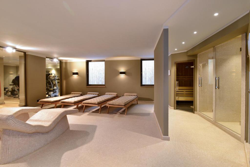 a waiting room with a row of benches in a building at Monbijou Hotel in Berlin