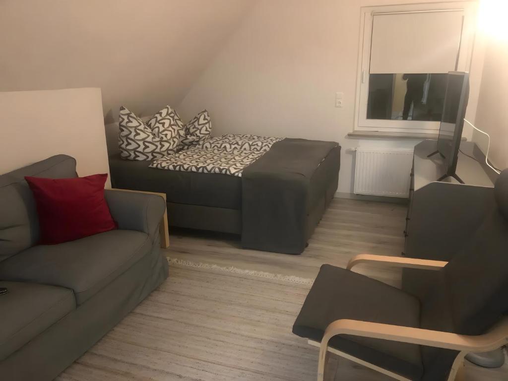 a small living room with a bed and a couch at Apartment Ballova in Balve