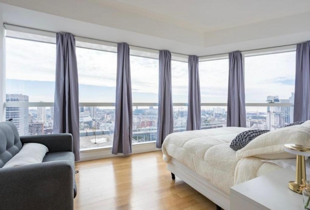 Giường trong phòng chung tại Exclusivo Apartamento con pileta, jacuzzi, gym y vista