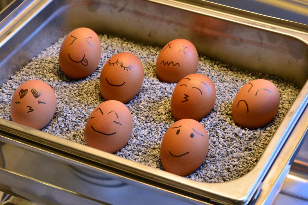 a group of eggs with faces drawn on them at Monbijou Hotel in Berlin