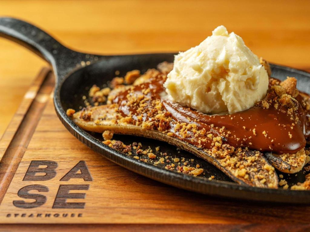 a skillet with a desert with a scoop of ice cream at Pullman Sao Paulo Guarulhos Airport in Guarulhos