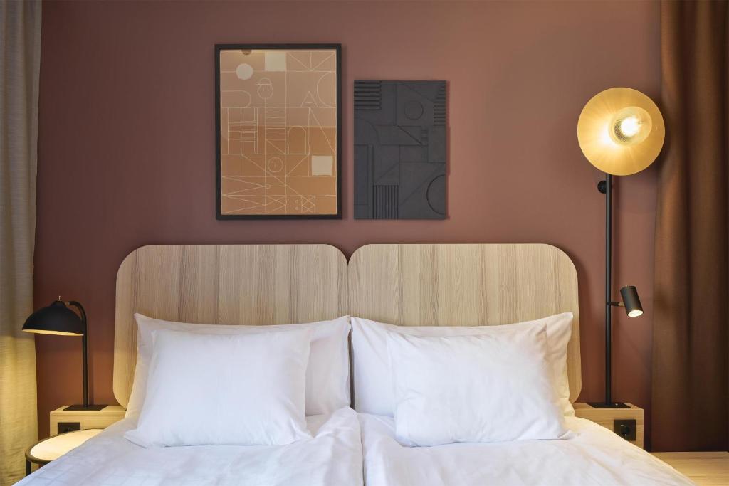a bedroom with a bed with white pillows at Scandic Malmen in Stockholm