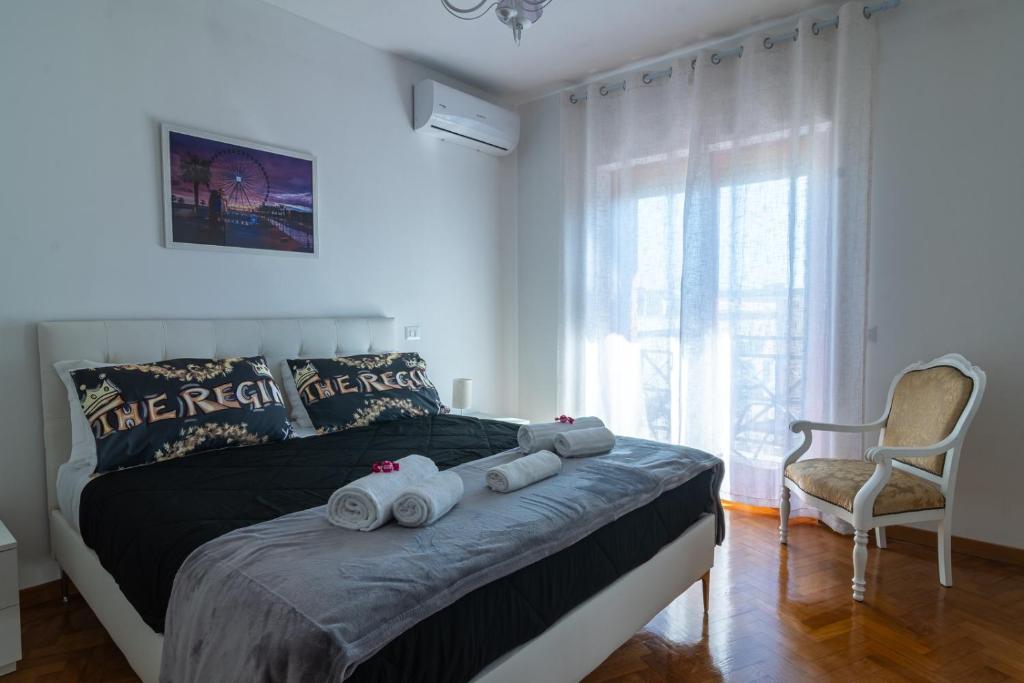 a bedroom with a bed with towels on it at The Regin in Civitavecchia