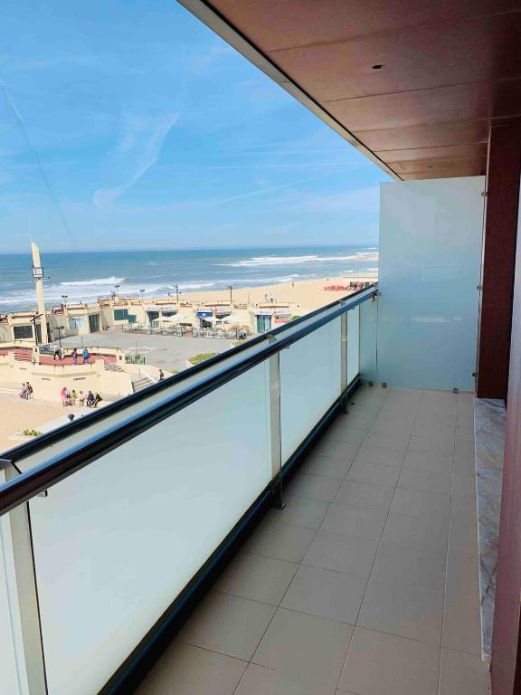 a balcony with a view of the beach at Póvoa TOP - Beachfront in Póvoa de Varzim