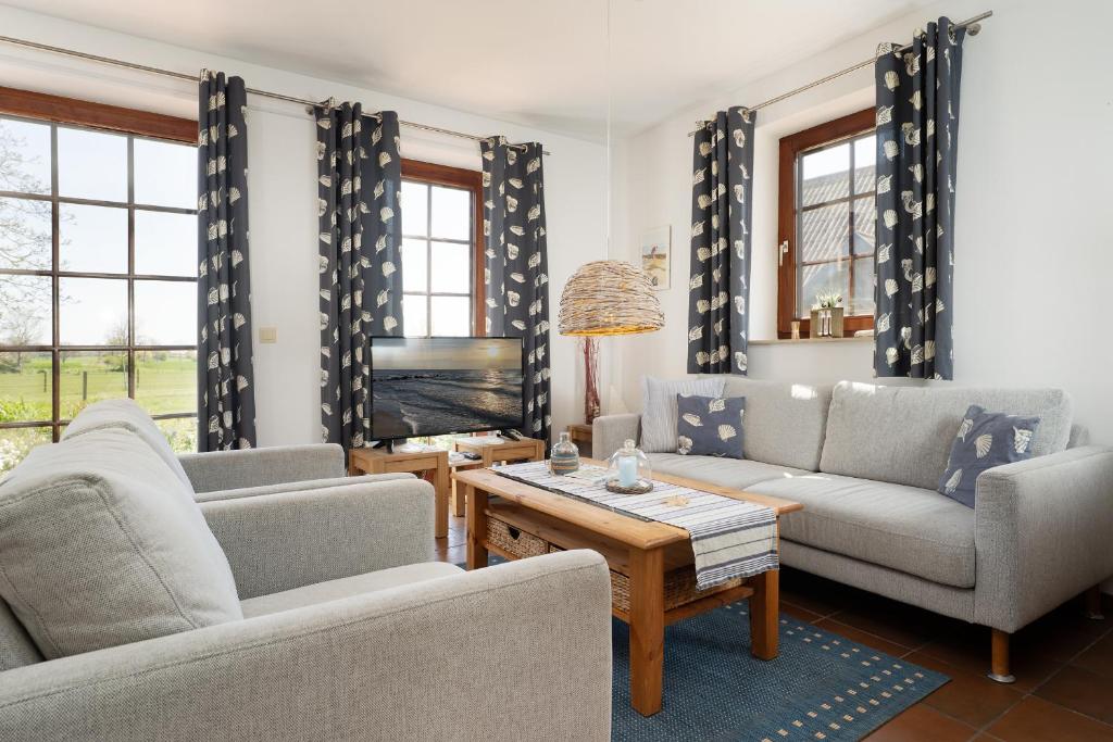 a living room with two couches and a tv at Ferienhaus May App 1 in Sahrensdorf
