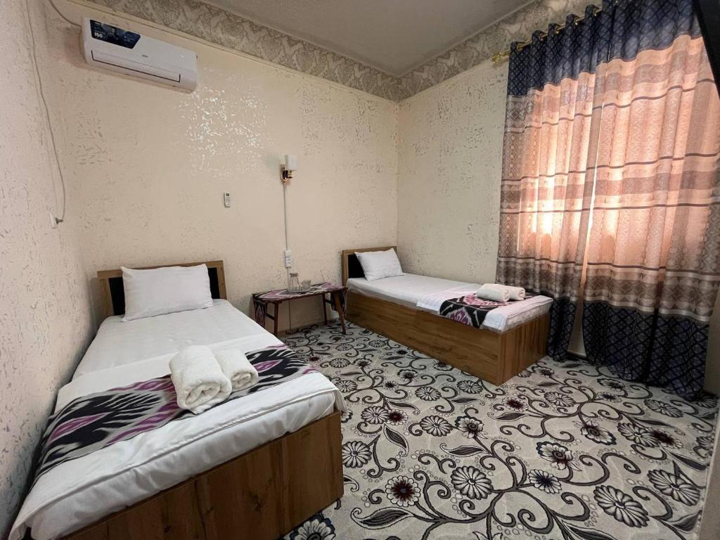 Ένα ή περισσότερα κρεβάτια σε δωμάτιο στο Oybek Hotel
