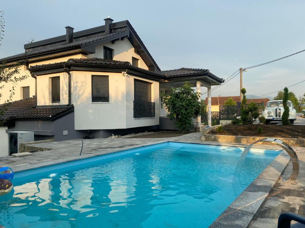 a swimming pool in front of a house at Villa Aldina Apartment 2 in Bihać