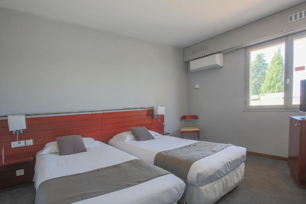 Postel nebo postele na pokoji v ubytování Hotel Brise de Mer - Piscine intérieure & extérieure