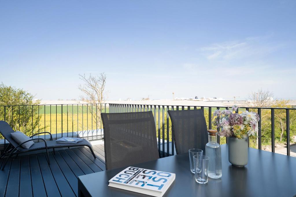 a black table and chairs on a balcony at Beltblick in Marienleuchte