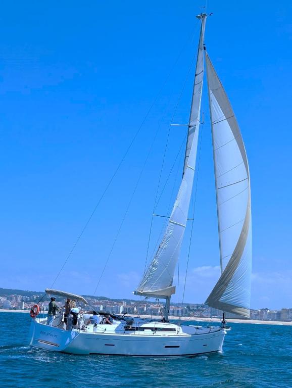 a white sailboat in the water on the ocean at PRIMO by Mondego Yachts in Figueira da Foz