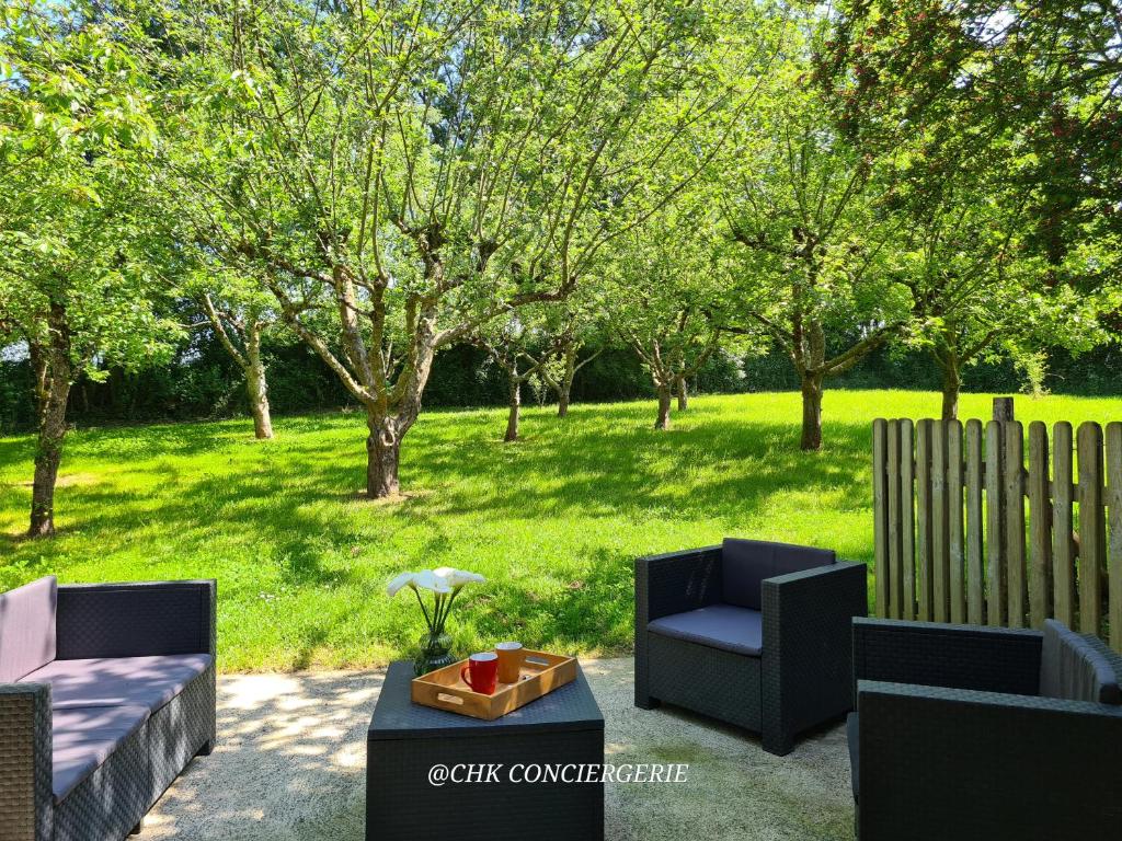 - une terrasse avec 2 chaises et une table dans un parc dans l'établissement Le Hameau 2 gîtes pour 15 personnes nature et rivière proche du Puy duFou, à La Forêt-sur-Sèvre