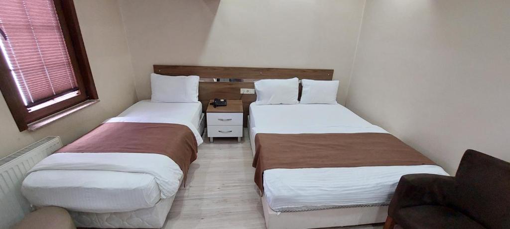 Postel nebo postele na pokoji v ubytování Divrigi Kosk Hotel