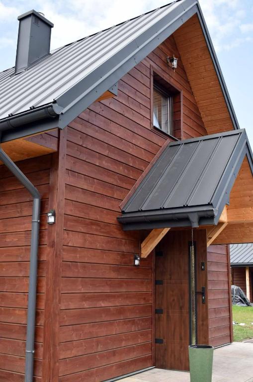 a metal roof on a building with a garage at Pod Roztoczańskim Niebem in Wólka Wieprzecka