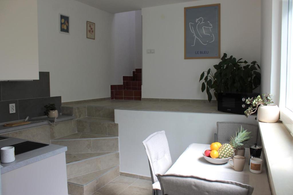 a kitchen with a table with a bowl of fruit on it at Horizont view apartment in Pula
