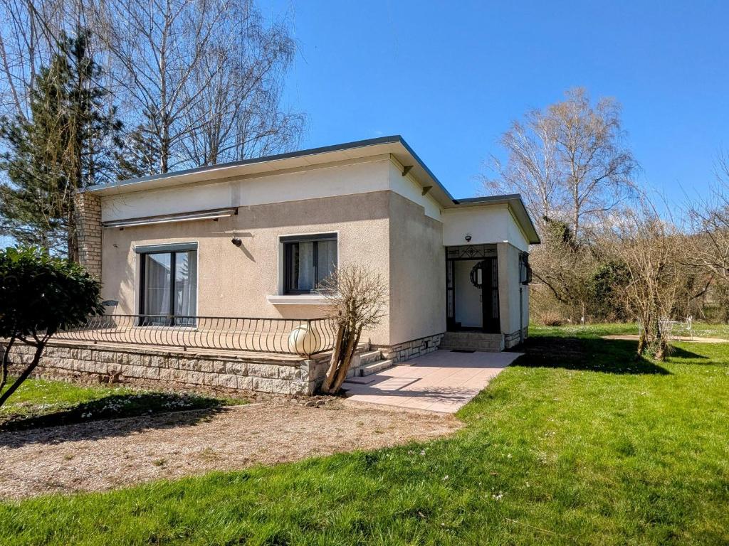 a small white house with a grass yard at Gîte rénové avec jardin à Vignot - FR-1-585-175 in Vignot