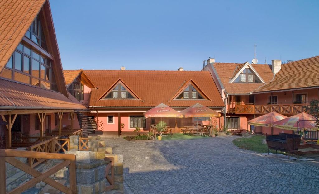 a group of buildings with umbrellas in a courtyard at Bezměrovský dvůr Kroměříž in Kroměříž