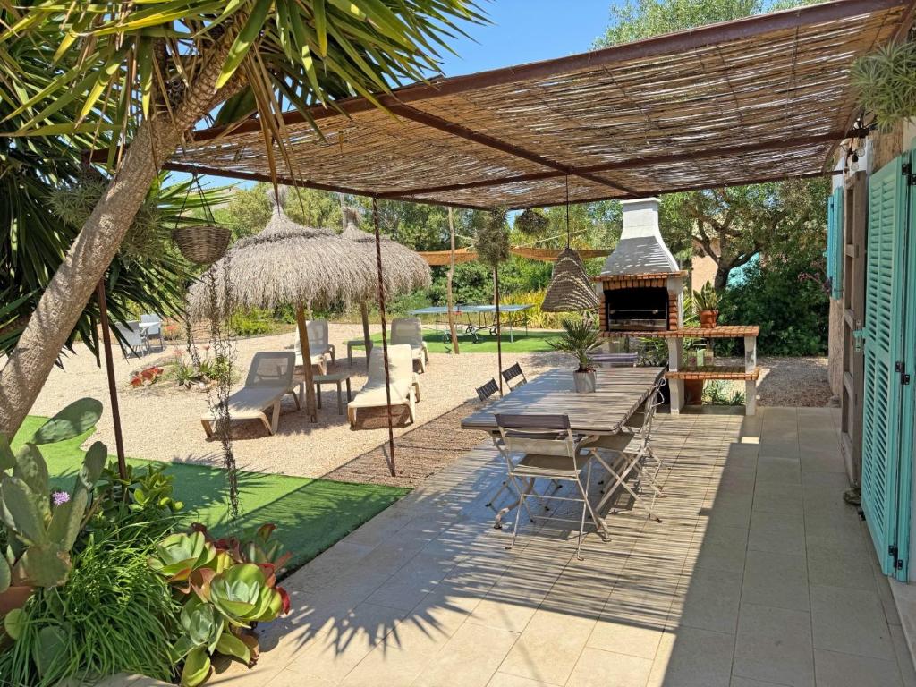 a patio with a table and a grill at Can Torres in Pòrtol